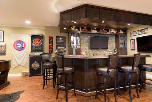 Interior indianapolis basement remodel with wood bar and barstools