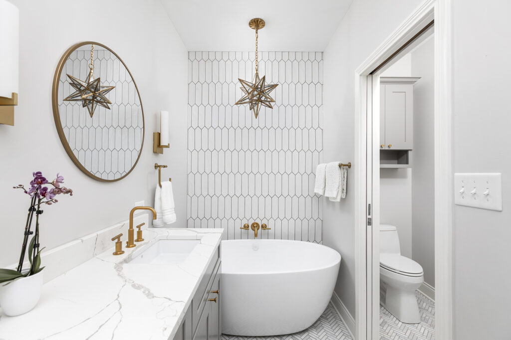 White bathroom remodel with a freestanding tub and double vanity