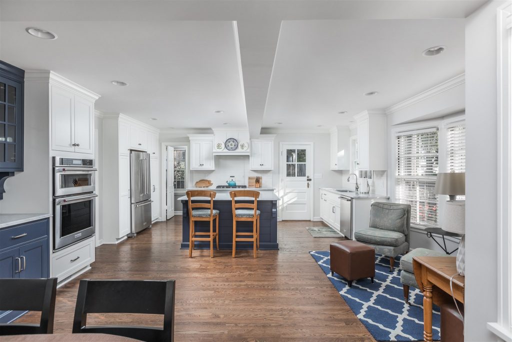 an open concept living space leaves the room for a bright and beautiful cape cod style kitchen, with eating and living spaces attached; whole house makeover