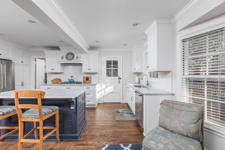 the new cape cod kitchen brings a bright and light aesthetic to this whole house makeover, with crisp white cabinets and blue accents throughout