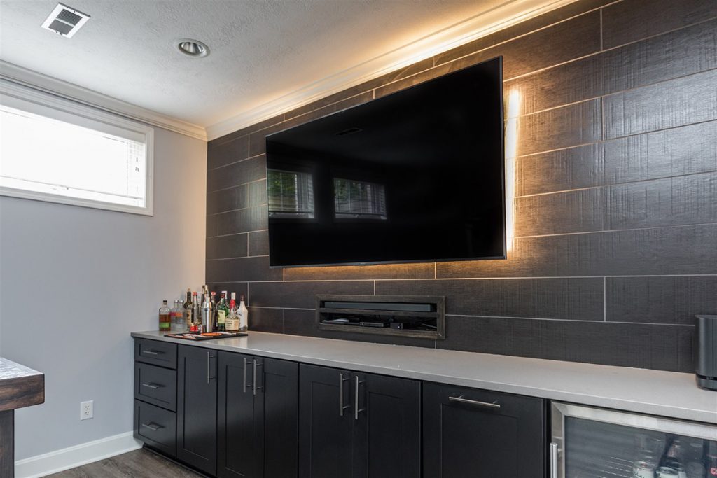 if you remodel instead of move, consider adding personal touches like a wet bar in the basement and a backlit flatscreen for hosting games and movie nights