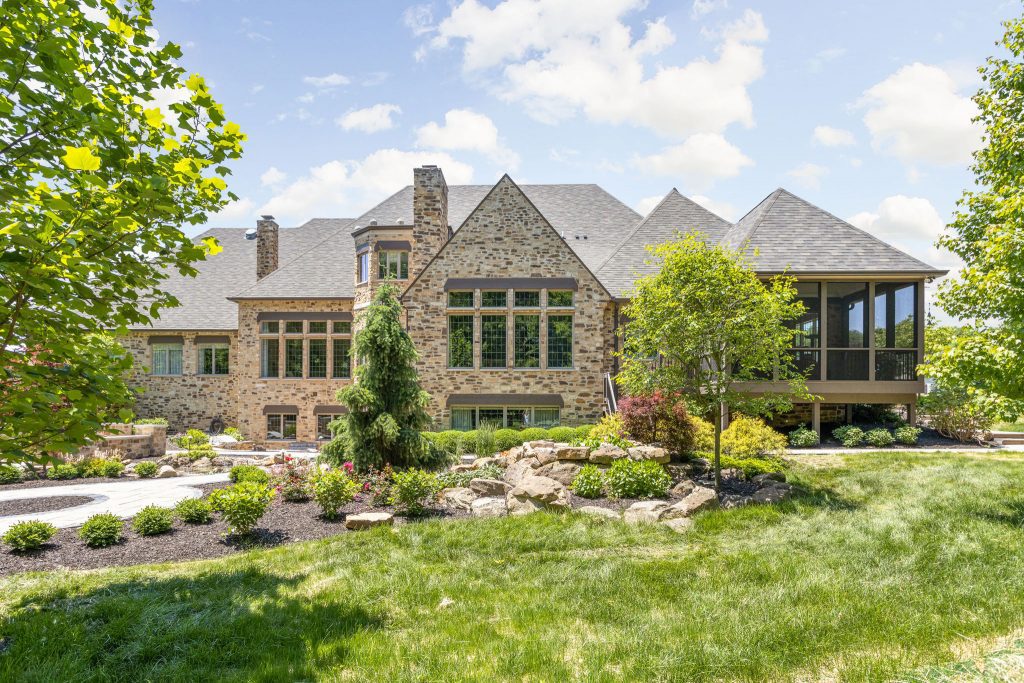 the fully remodeled exterior of this zionsville home includes a new screened in porch, relocated stairs and a freshly landscaped pathway