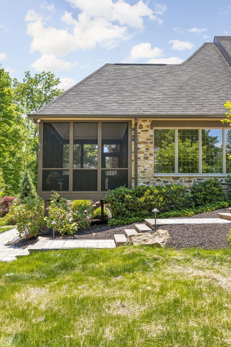 the stairs heading down from the front entrance lead back to the newly remodeled screened in porch