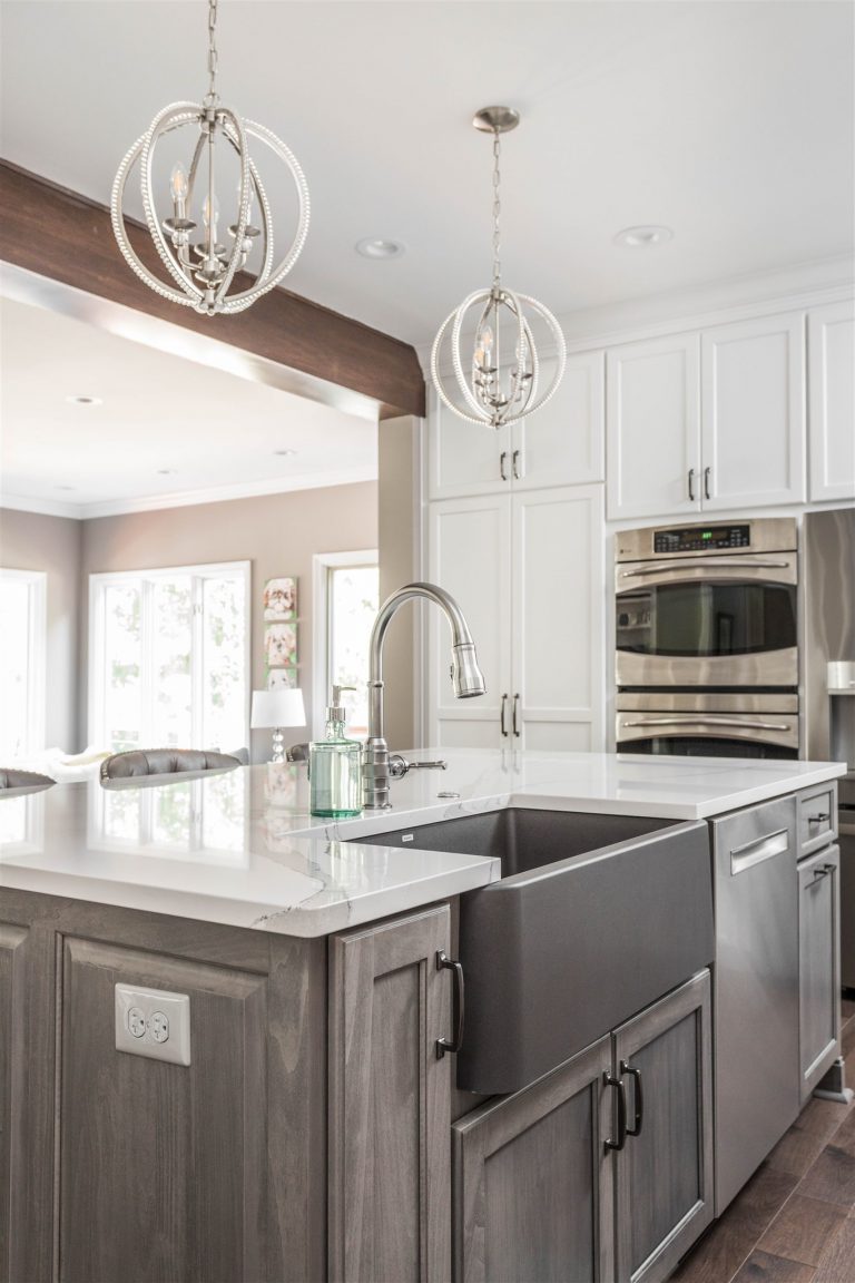 the light gray island keeps the bright and open feeling consistent throughout the white kitchen