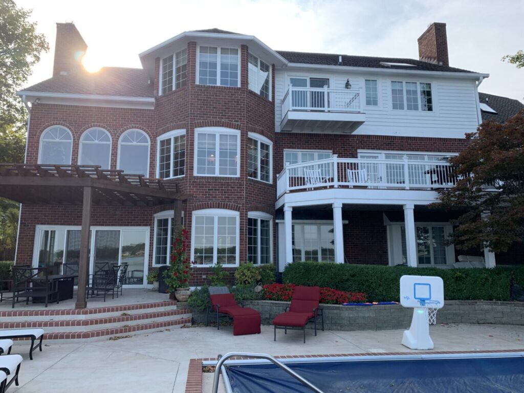 The original 1988 brick exterior of a Geist Reservoir home before the structural facade updates and painting process.