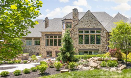 picture of a stone house with lots of windows for sunshine after a whole house remodel by worthington design and remodeling