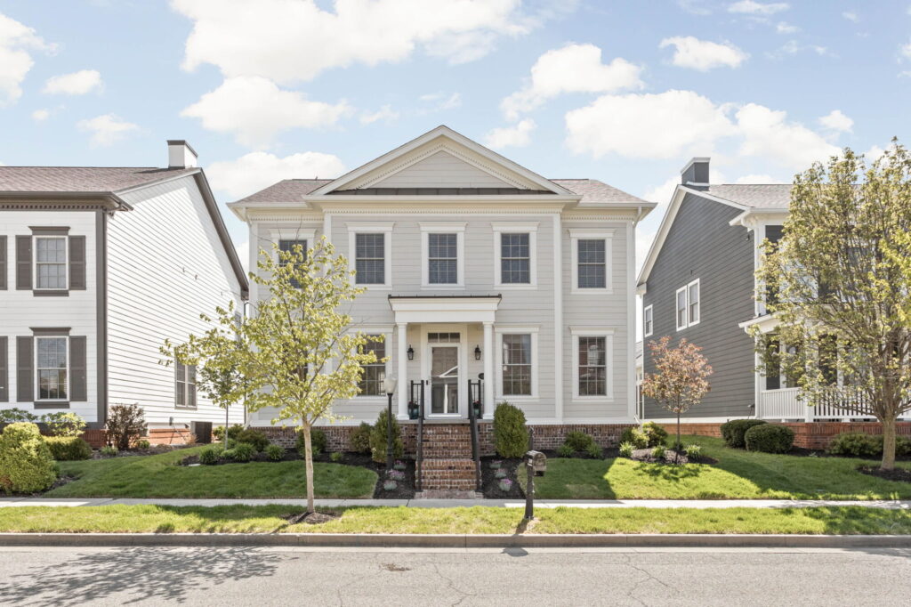 Front exterior of a Carmel home with a new portico