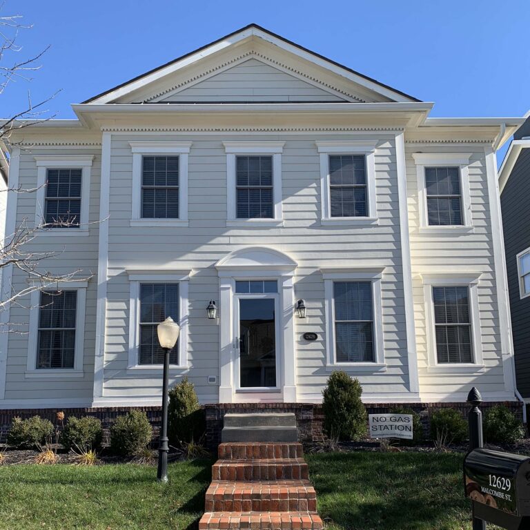 Before photo of a Carmel home exterior lacking a front portico and updated steps.