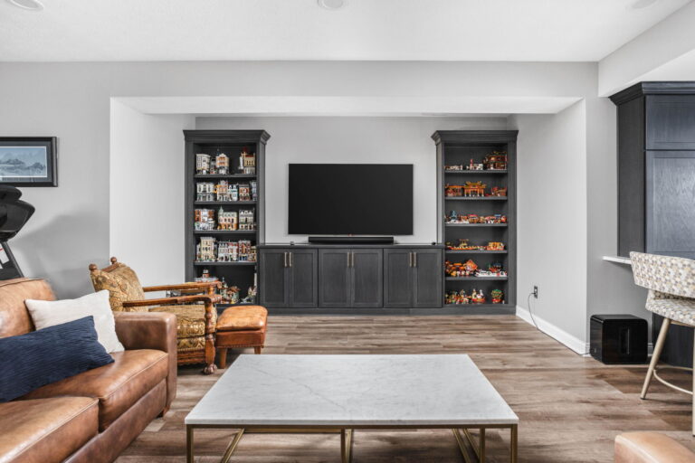 Carmel basement gathering room with custom media built-ins and display shelving