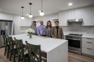 Four Worthington team members in a white kitchen.