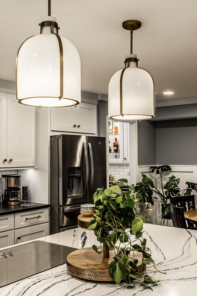 Wet bar in an Indianapolis remodel with custom cabinetry, countertop surface, backsplash tile, and integrated lighting