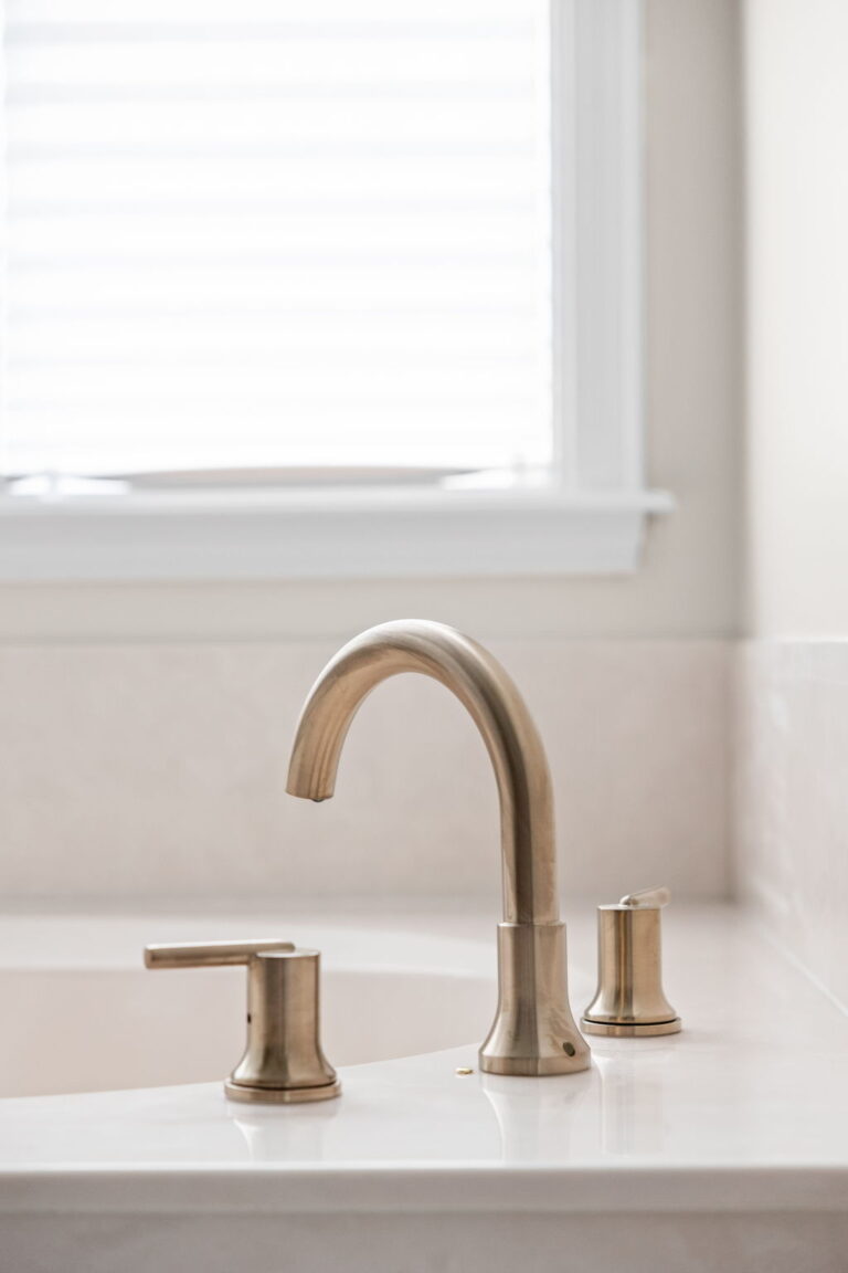 A Carmel, IN Bathroom Renovation picture showing a tub faucet in matte brass.