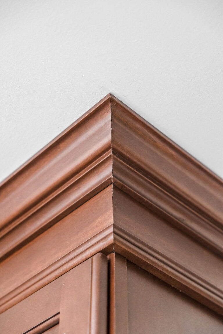 A Carmel, IN Bathroom Renovation picture showing the detail of the rich wood stained crown moulding.