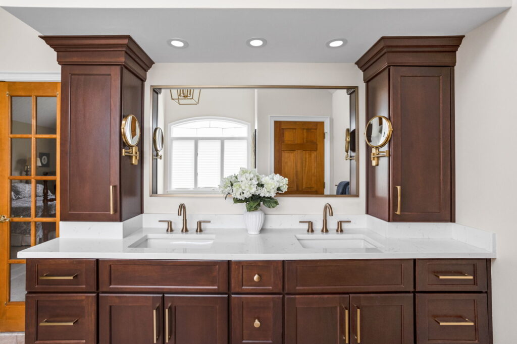 A Carmel, IN Bathroom Renovation picture showing a double vanity in a rich toned stain.