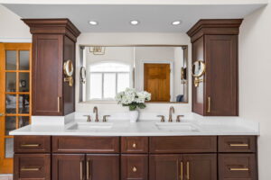 A Carmel, IN Bathroom Renovation picture showing a double vanity in a rich toned stain.