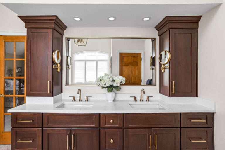 A Carmel, IN Bathroom Renovation picture showing a double vanity in a rich toned stain.