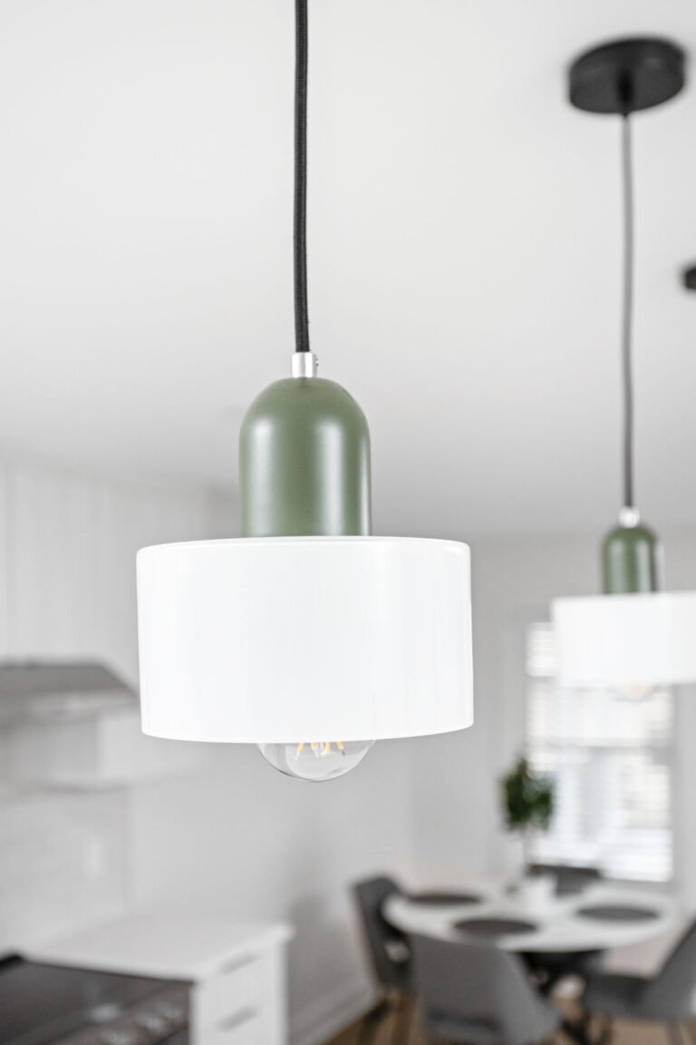 pendant light with green housing and frosted white glass shade