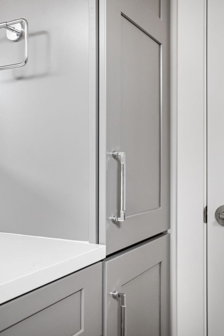 bathroom renovation with gray cabinets and white countertops