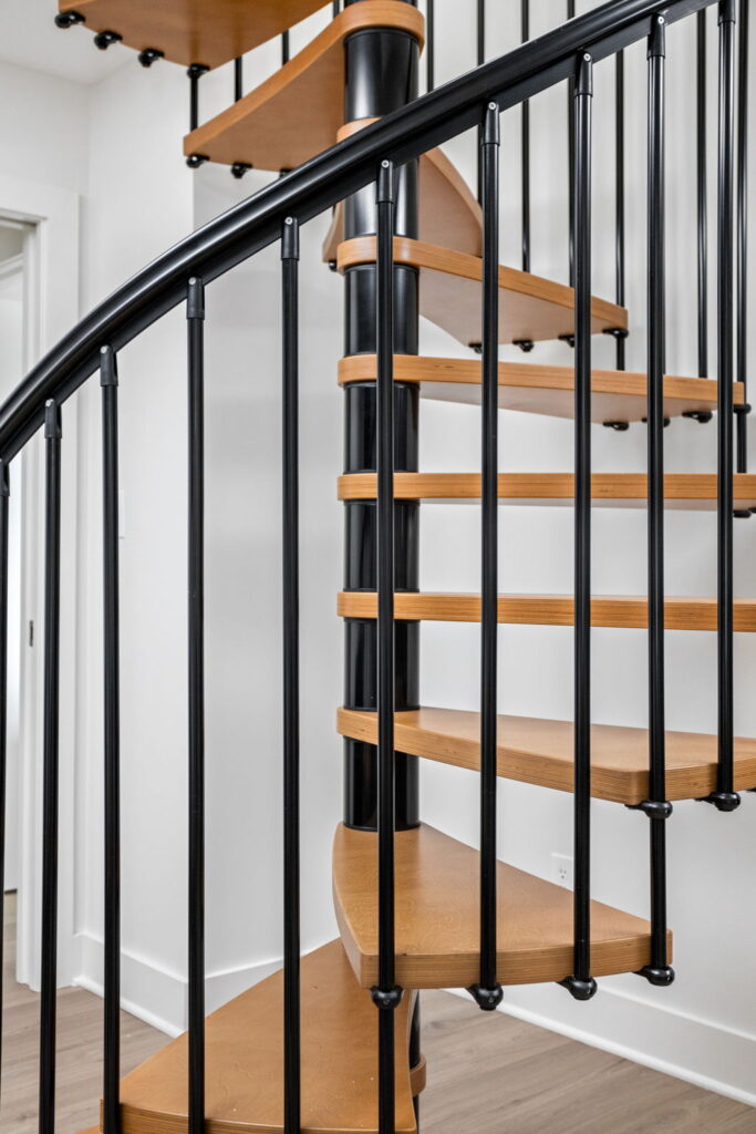spiral staircase in a living room with wood stairs and black railing in indianapolis, Indiana