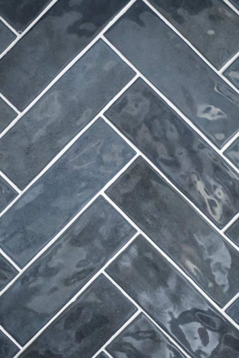 Carmel kitchen renovation refresh featuring refinished cabinetry, new buffet, bold tile, and timeless upgrades by Worthington Design & Remodeling. Photo shows close up of dark blue tile on backsplash.