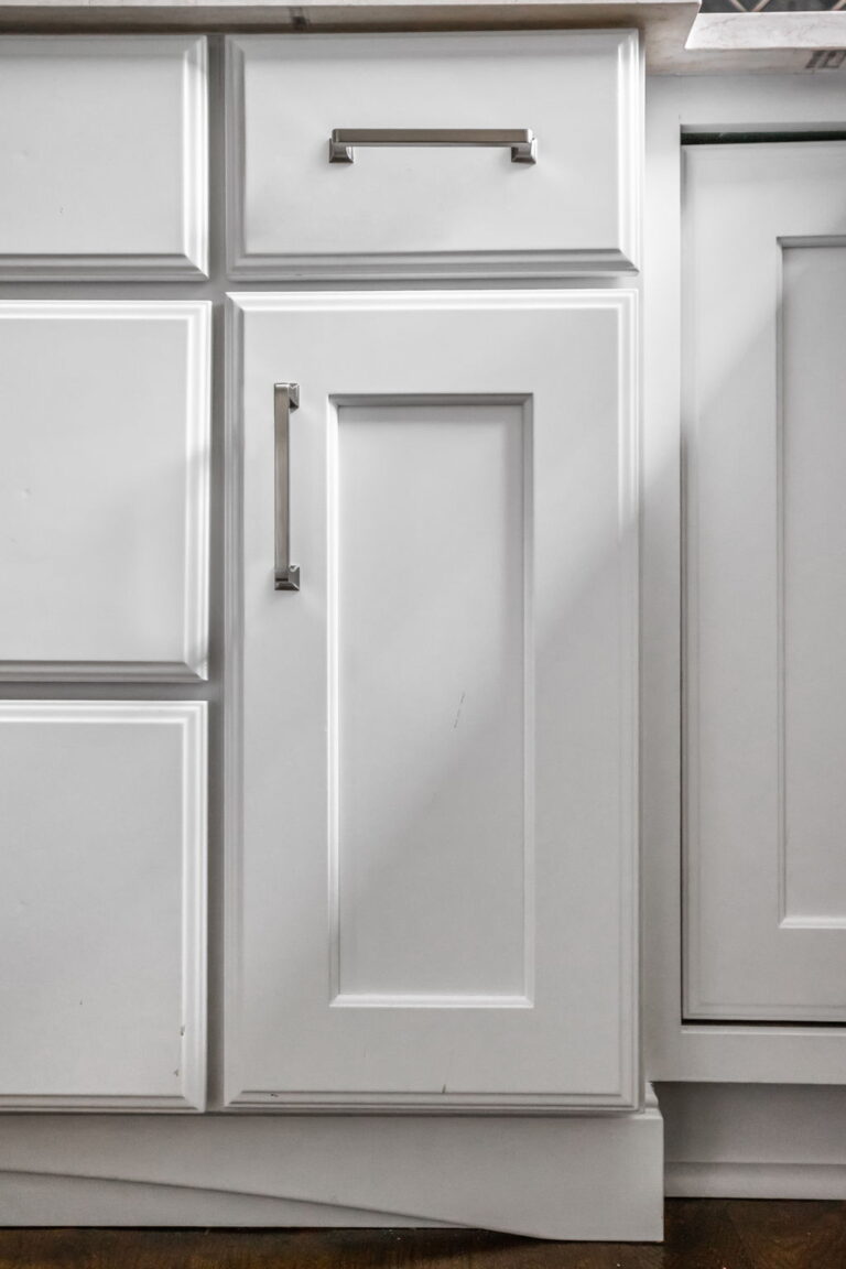 Carmel kitchen renovation refresh featuring refinished cabinetry, new buffet, bold tile, and timeless upgrades by Worthington Design & Remodeling. Photo shows close up of base cabinetry details.