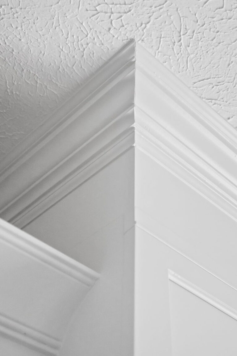 Carmel kitchen renovation refresh featuring refinished cabinetry, new buffet, bold tile, and timeless upgrades by Worthington Design & Remodeling. Photo shows close up of crown moulding detail.