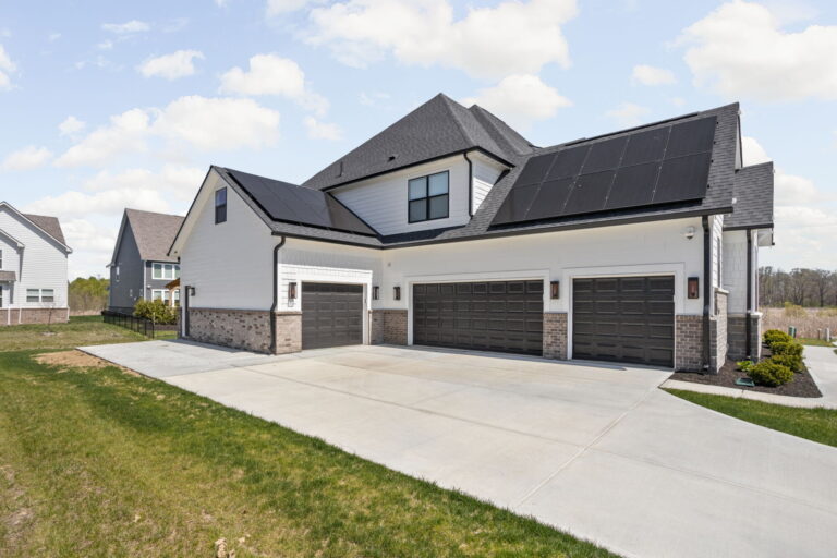 Multi-bay garage addition with modern siding and brickwork by home addition contractor Carmel IN.