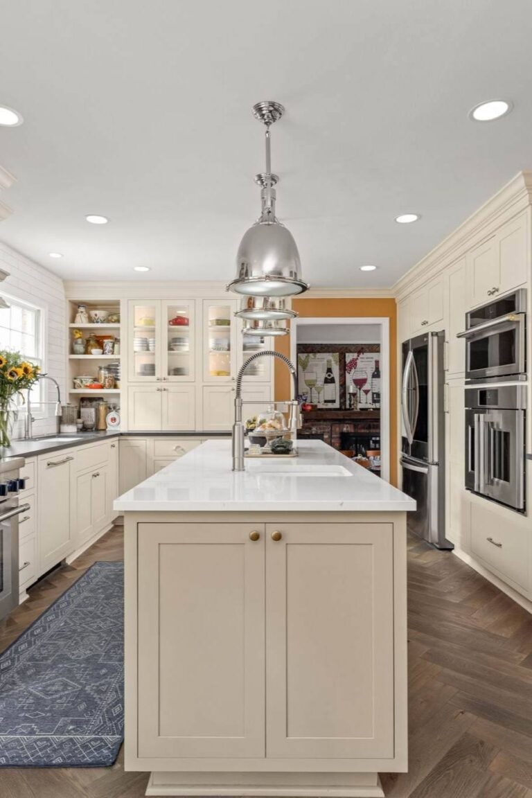 Main prep island detail with gooseneck faucet and quartz top centered between built-ins—part of a whole-home remodel.