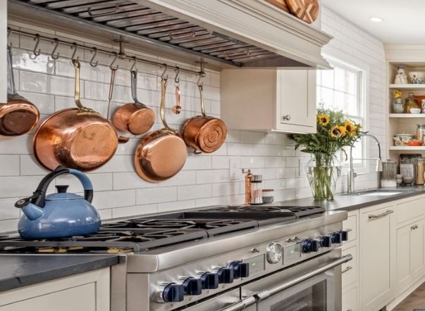 A range with copper pots above.