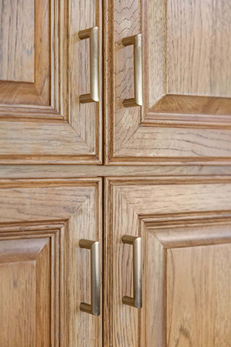 Close up of repurposed oak cabinet doors with brushed brass hardware in a Lebanon Indiana kitchen refresh.