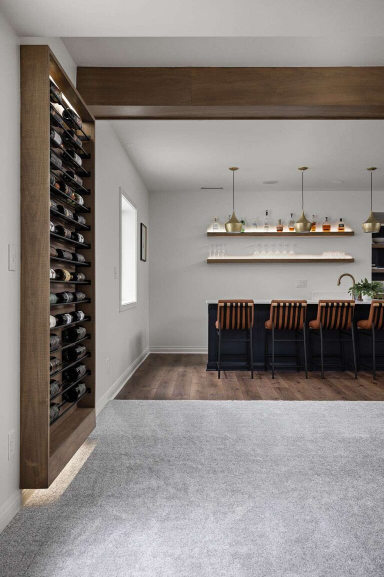 Custom wine storage wall in a Carmel IN basement renovation with floor-to-ceiling bottle racks.