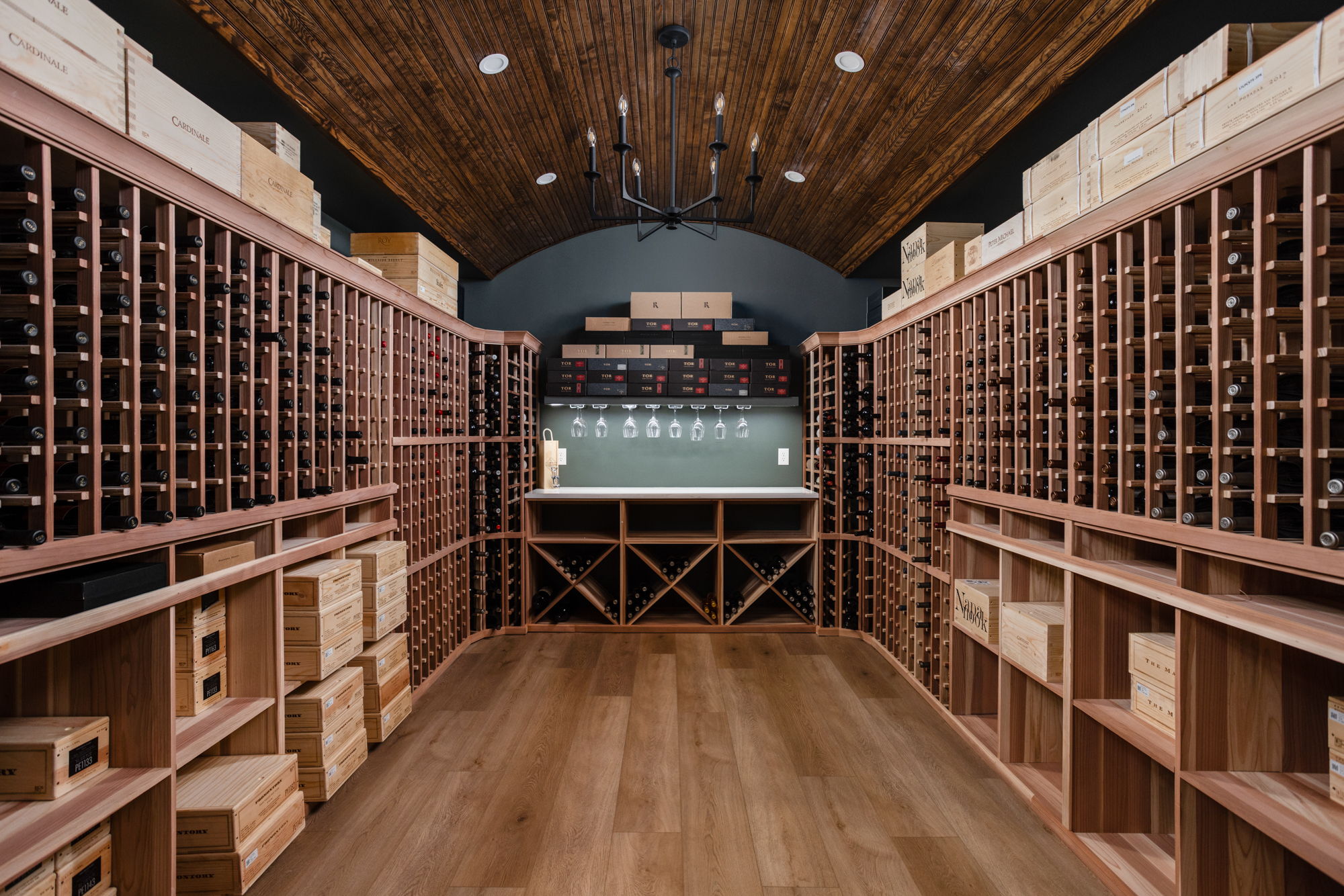 Custom wine cellar in a Carmel, Indiana basement remodel featuring built in wine racks, a quartz serving counter, accent lighting, and climate control planning by Worthington Design and Remodeling