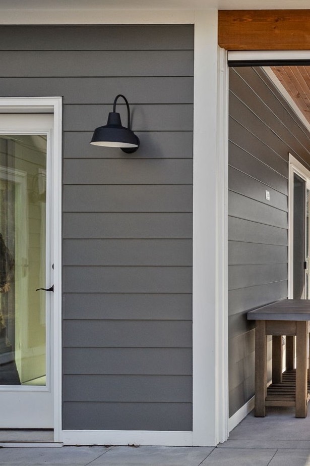 Close up of exterior coach light mounted on the covered patio siding, four season room addition.