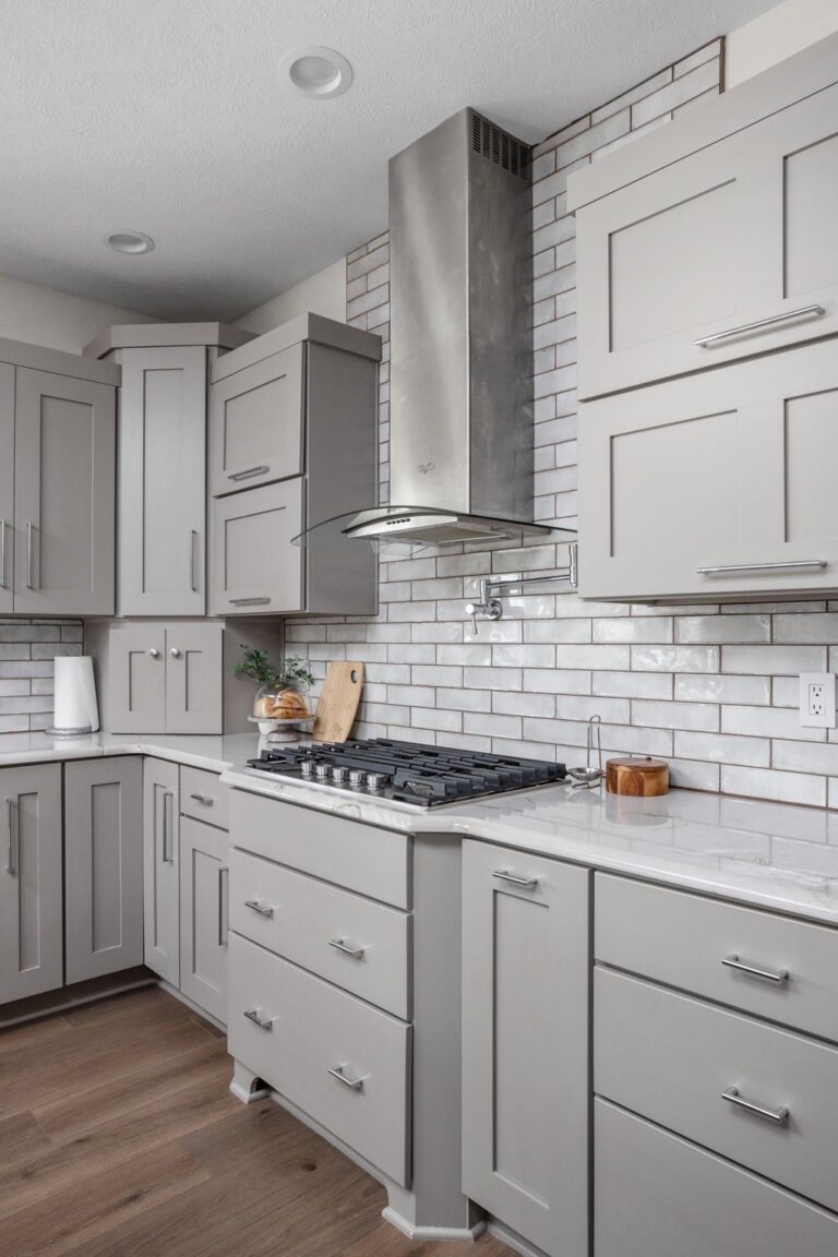 Kitchen range and hood with tile backsplash and countertop surface, four season room addition
