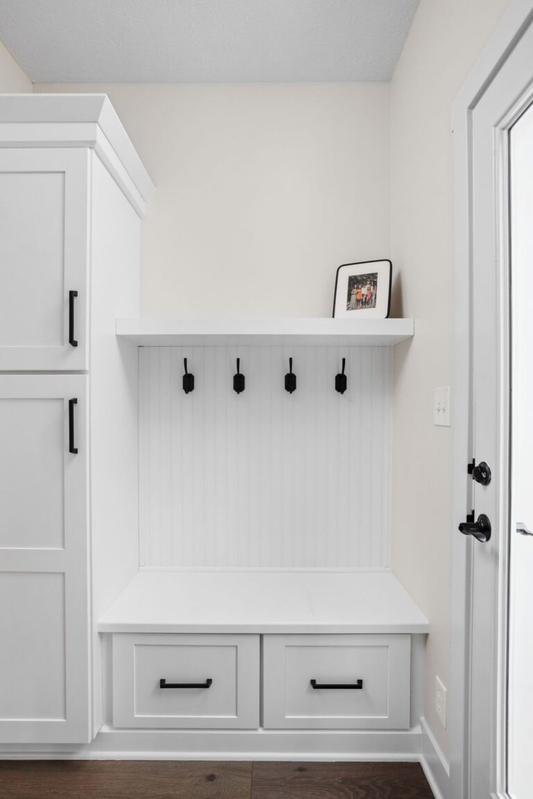 Mudroom bench and hook wall detail with cabinetry at the entry, four season room addition.