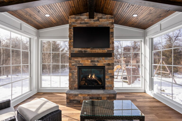 Close detail of stone fireplace hearth in home addition remodel Carmel IN sunroom.