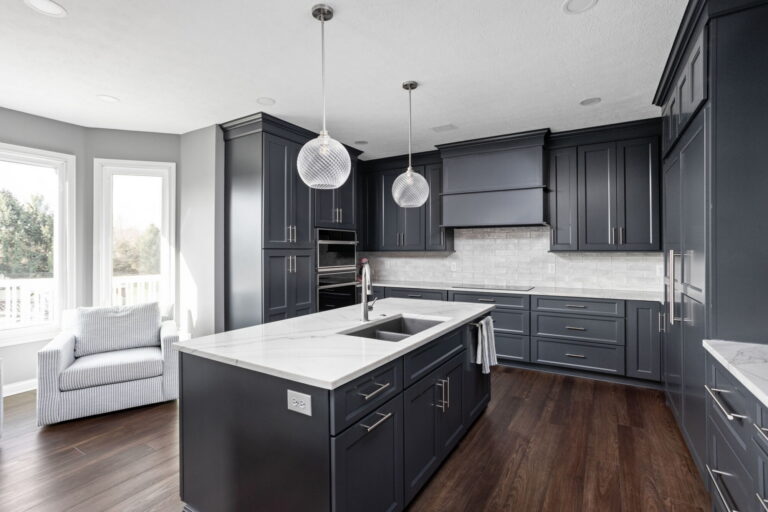 Wide kitchen view from this Fishers kitchen and bath remodel showing the main island, custom cabinetry, and pendant lighting over the work zone.