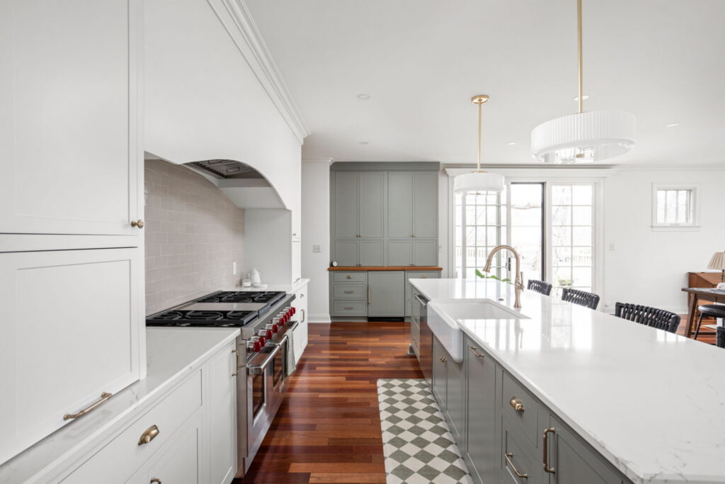 Kitchen perspective showing Wolf range, custom hood, and painted cabinetry in Zionsville home