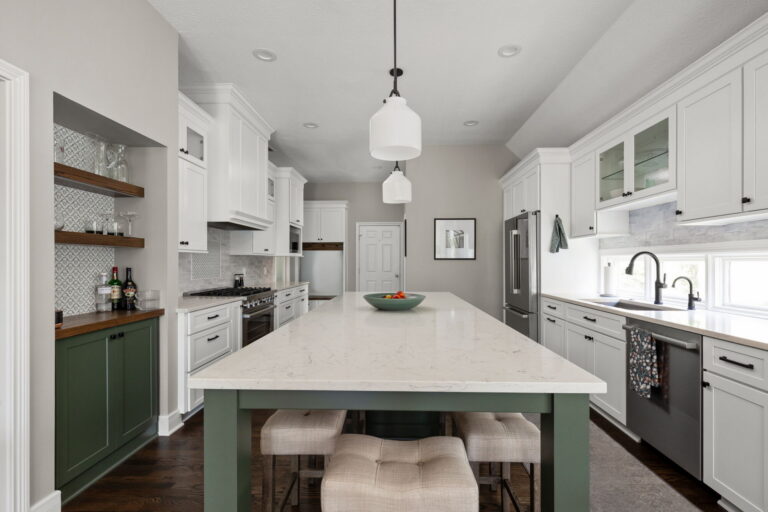 Finished Fishers kitchen remodel with a green island, white perimeter cabinetry, MSI quartz countertops, and black hardware.