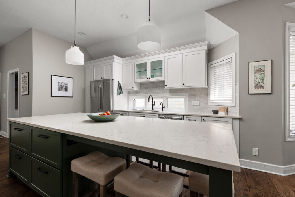 Open Fishers kitchen remodel with MSI quartz island, white cabinetry, green island base, pantry nook, and improved layout.