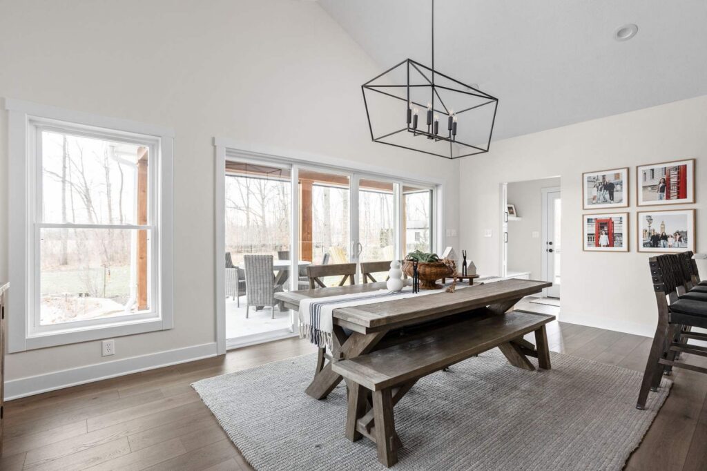 Sunroom dining area in Indianapolis addition with large sliding doors opening to the covered porch.