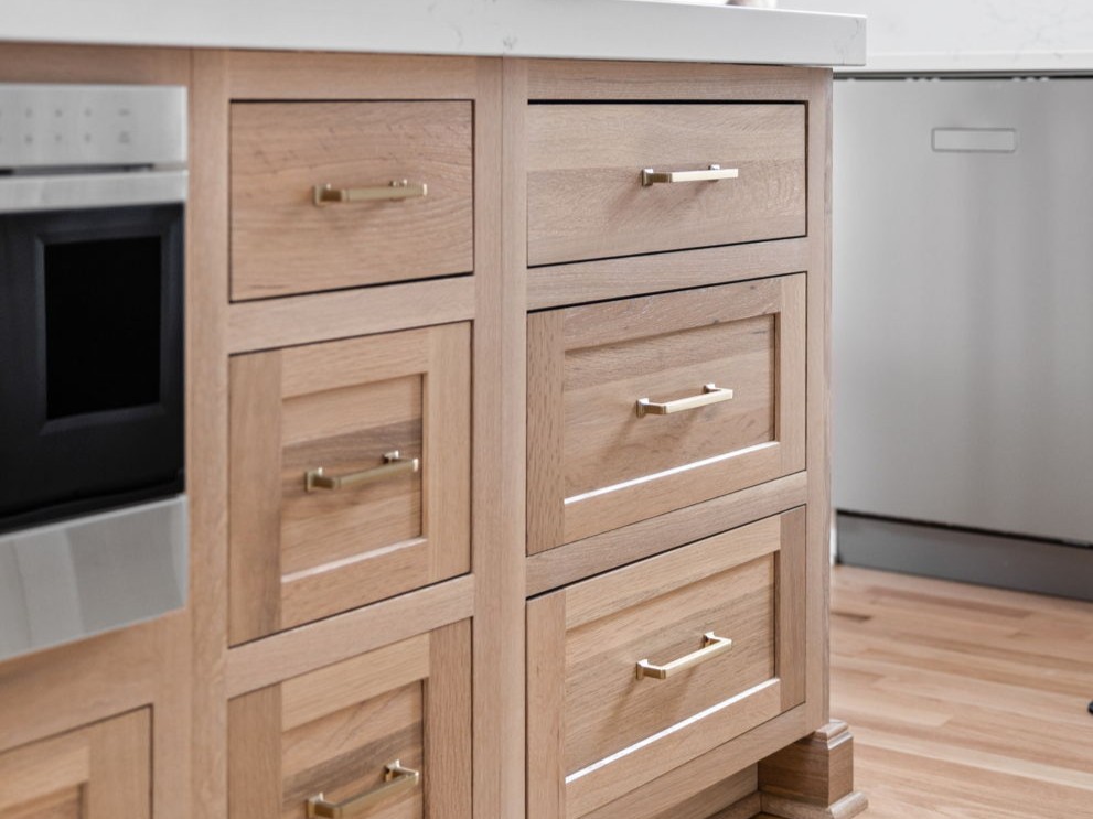 This luxury 2026 kitchen remodel in Carmel IN features warm wood Shiloh Cabinetry, a quartzite waterfall island, and curated collected details by Worthington Design & Remodeling.