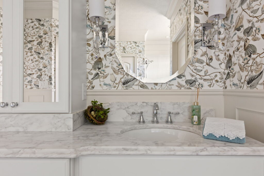 MSI Calacatta Ocellio quartz countertop with Delta Cassidy chrome faucet in a luxury Westfield primary bathroom remodel.