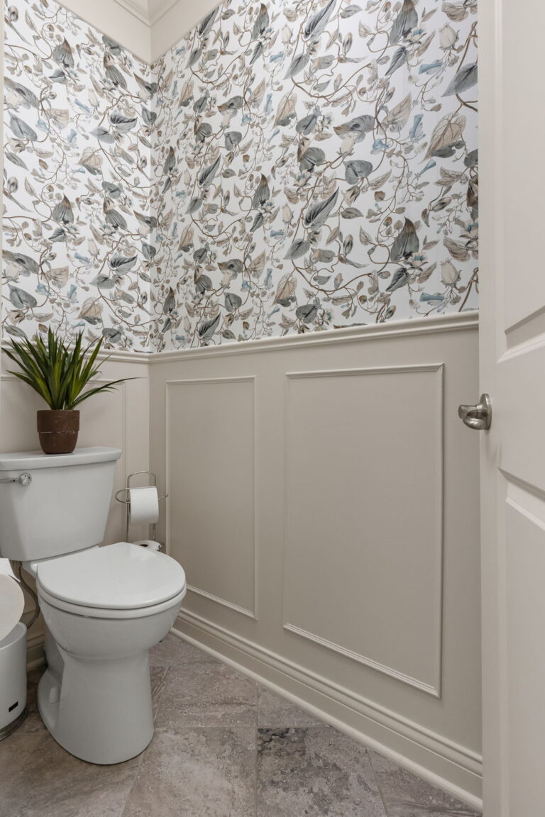 Westfield primary bathroom water closet with York Wallcoverings Moon Flower wallpaper above painted panel molding for a refined luxury bathroom refresh.