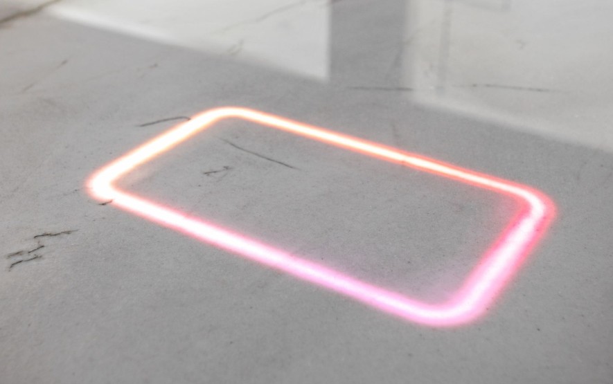 Custom integrated FreePower in-counter wireless phone charger outline glowing on a Cambria quartz countertop inside a Carmel kitchen.
