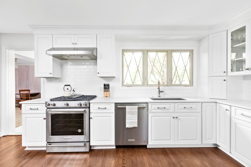 White kitchen cabinetry and original diamond-pane windows in a Meridian-Kessler kitchen remodel