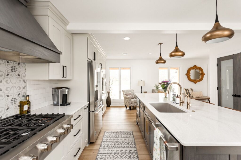 Large multi-purpose kitchen island with durable quartz countertops and dark wood base cabinetry.