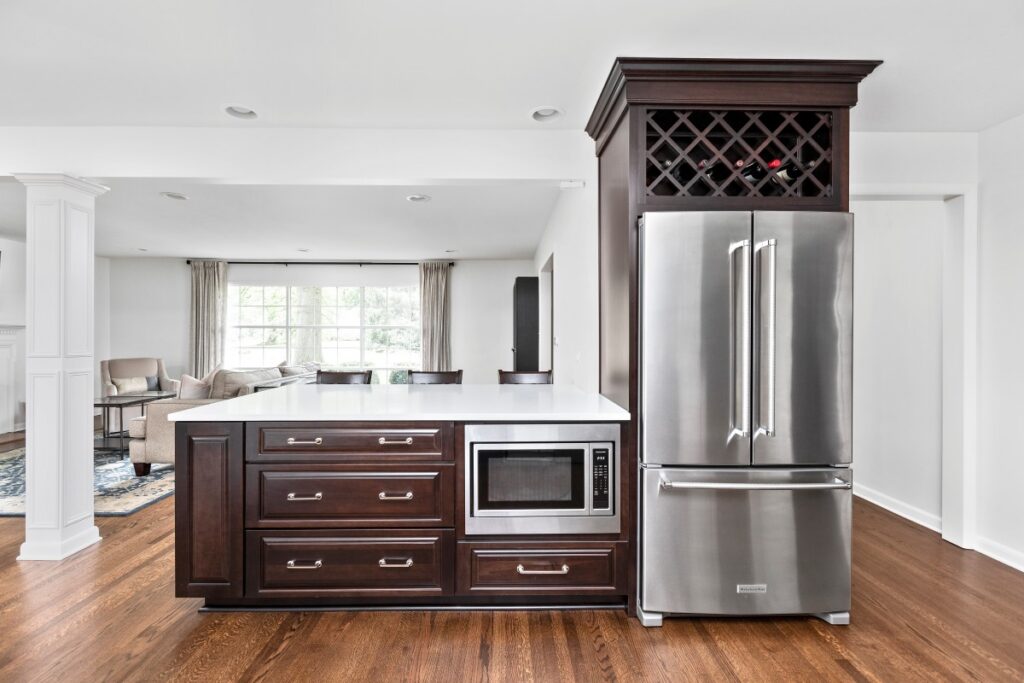 Dark kitchen island opening to the living room in a Meridian-Kessler home remodel