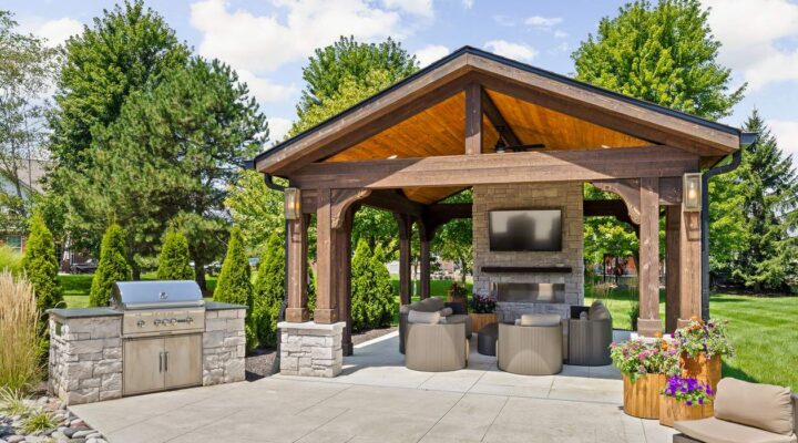 A Backyard Pavilion with a Stone Fireplace in Carmel