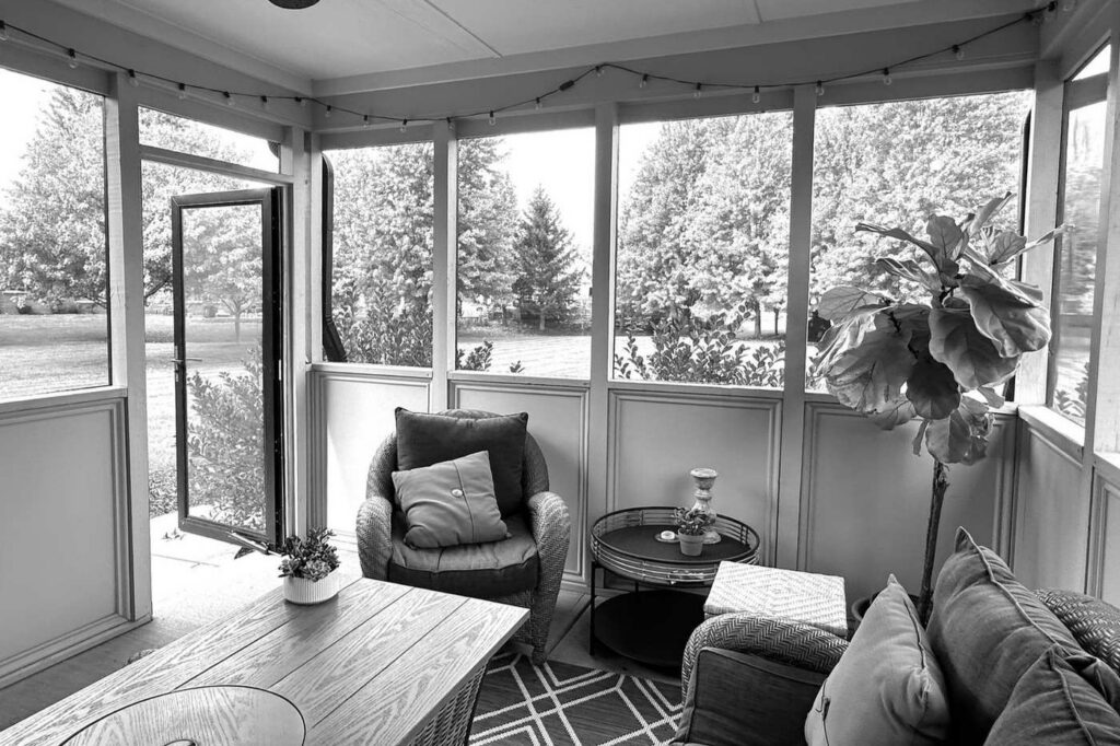 Before: Screened porch with a hinged screen door and solid lower wall panels.